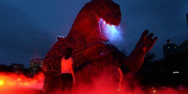 A 6.6 meter tall godzilla statue is illuminated at the Midtown park in Tokyo for the promotion of the recent godzilla movie at a press preview on July 17, 2014. The light-up godzilla from July 18 through the end of August. AFP PHOTO / Yoshikazu TSUNO (Photo credit should read YOSHIKAZU TSUNO/AFP/Getty Images)