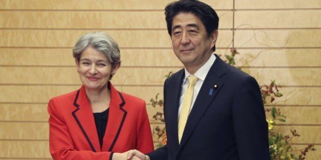 Director General of UNESCO Irina Bokova (L) shakes hands with Japanese Prime Minister Shinzo Abe prior to their meeting at Abe's official residence in Tokyo on November 7, 2014. AFP PHOTO / POOL (Photo credit should read KOJI SASAHARA/AFP/Getty Images)