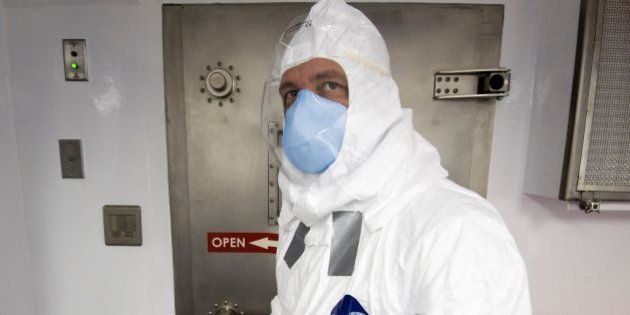 A member of a medical team is seen inside a Containerized Bio-Containment System (CBCS) during a shake-down exercise at Dulles International Airport in Virginia, outside Washington, DC on November 18, 2016 after return with simulated patients infected with Ebola from West Africa. This revolutionary biosecurity infectious disease transport unit can be loaded into large cargo aircraft and transport up to four infected patients. / AFP / PAUL J. RICHARDS (Photo credit should read PAUL J. RICHARDS/AFP/Getty Images)
