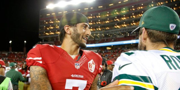 San Francisco 49ers quarterback Colin Kaepernick, left, greets Green Bay Packers quarterback Aaron Rodgers at the end of an NFL preseason football game Friday, Aug. 26, 2016, in Santa Clara, Calif. Green Bay won 21-10. (AP Photo/Tony Avelar)