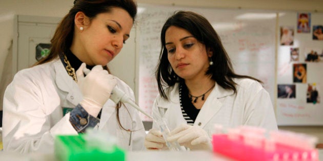 Laboratory experts work on DNA samples to identify the bodies of victims of the Ethiopian Airlines Boeing 737 plane that crashed into the sea on Monday, at Beirut's government hospital, Lebanon, Wednesday, Jan. 27, 2010. Emergency workers searched deep in the sea Wednesday for the black boxes from a doomed Ethiopian Airlines jet as DNA tests helped identify several bodies that had been pulled from the Mediterranean. All 90 people on board were feared dead. (AP Photo/Bilal Hussein)