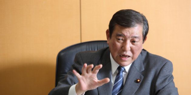 Shigeru Ishiba, Japan's minister in charge of overcoming population decline and vitalizing local economy, gestures as he speaks during an interview in Tokyo, Japan, on Wednesday, Jan. 21, 2015. The Abe government's chief for regional Japan looks into the future and sees enterprising communities that maintain their grip on state funding and flourish, and stragglers that are cut loose. Photographer: Tomohiro Ohsumi/Bloomberg via Getty Images