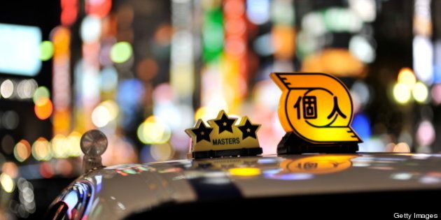 [UNVERIFIED CONTENT] A taxi in shinjyuku tokyo. The background are the buildings lining the kabukicho area. Extremely colourful lights. Taxi top. Three stars and private taxi. White taxi at night. out of focus bokeh nightlife