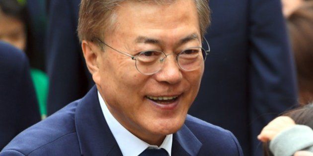 South Korean presidential candidate Moon Jae-In (C) of the Democratic Party greets his supporters as he arrives at a polling station in Seoul on May 9, 2017.South Koreans went to the polls on May 9 to choose a new president after Park Geun-Hye was ousted and indicted for corruption, and against a backdrop of high tensions with the nuclear-armed North. / AFP PHOTO / JUNG Yeon-Je (Photo credit should read JUNG YEON-JE/AFP/Getty Images)
