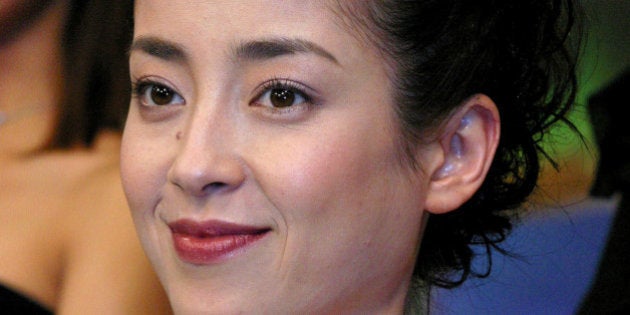 TOKYO - MARCH 7: Japanese actress Rie Miyazawa holds a trophy at the Japan Academy Prize 2003 March 7, 2003 in Tokyo, Japan. Miyazawa received the outstanding performance by an actress in a leading role prize. (Photo by Junko Kimura/Getty Images)