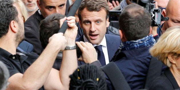 Emmanuel Macron, head of the political movement En Marche !, or Onwards !, and candidate for the 2017 presidential election, speaks with supporters during a campaign visit in Rodez, France, May 5, 2017. REUTERS/Regis Duvignau