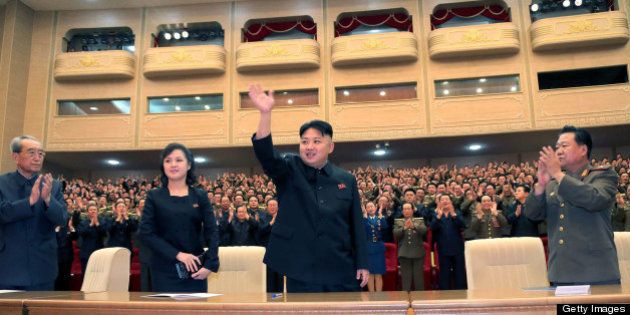 This undated picture, released by North Korea's official Korean Central News Agency (KCNA) on May 13, 2013 shows North Korean leader Kim Jong Un (C), accompanied by his wife Ri Sol Ju (2nd L), enjoying performance given by the Song and Dance Ensemble of the Korean People's Internal Security Forces (KPISF) in Pyongyang. AFP PHOTO / KCNA via KNS THIS PICTURE WAS MADE AVAIALBLE BY A THIRD PARTY. AFP CAN NOT INDEPENDENTLY VERIFY THE AUTHENTICITY, LOCATION, DATE AND CONTENT OF THIS IMAGE. THIS PHOTO IS DISTRIBUTED EXACTLY AS RECEIVED BY AFP. ---EDITORS NOTE--- RESTRICTED TO EDITORIAL USE - MANDATORY CREDIT 'AFP PHOTO / KCNA VIA KNS' - NO MARKETING NO ADVERTISING CAMPAIGNS - DISTRIBUTED AS A SERVICE TO CLIENTS (Photo credit should read KNS/AFP/Getty Images)