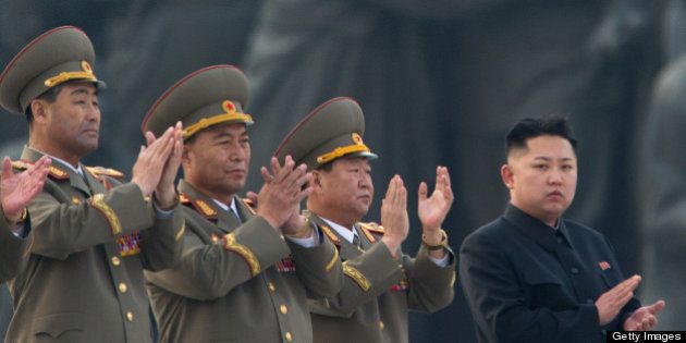 North Korean leader Kim Jong-Un (R) claps during the unveiling ceremony of two statues of former leaders Kim Il-Sung and Kim Jong-Il in Pyongyang on April 13, 2012. North Korea's new leader Kim Jong-Un on April 13 led a mass rally for his late father and grandfather following the country's failed rocket launch. AFP PHOTO / Ed Jones (Photo credit should read Ed Jones/AFP/Getty Images)
