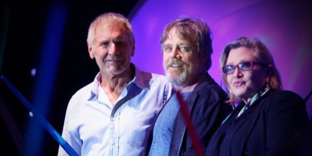 SAN DIEGO, CA - JULY 10: (EDITORS NOTE: This image was processed using digital filters.) (L-R) Actors Harrison Ford, Mark Hamill, Carrie Fisher and more than 6000 fans enjoyed a surprise 'Star Wars' Fan Concert performed by the San Diego Symphony, featuring the classic 'Star Wars' music of composer John Williams, at the Embarcadero Marina Park South on July 10, 2015 in San Diego, California. (Photo by Jesse Grant/Getty Images for Disney)