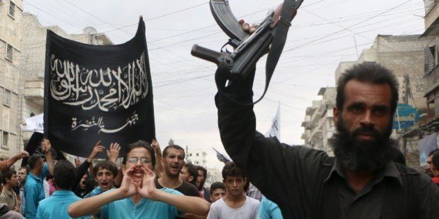 Supporters of the Al Nusra Front take part in a protest against Syrian President Bashar al-Assad and the international coalition in Aleppo on September 26, 2014. The US struck a little-known group called 'Khorasan' on September 24, but experts and activists argue it actually struck Al-Qaeda's affiliate Al-Nusra Front, which fights alongside Syrian rebels. AFP PHOTO/ Fadi al-Halabi (Photo credit should read Fadi al-Halabi/AFP/Getty Images)