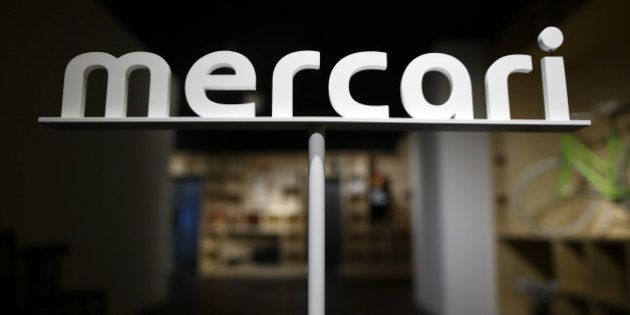 Logo of Mercari Inc. is displayed at the entrance to the company's office in Tokyo, Japan, on Friday, March 11, 2016. Mercari, a mobile e-commerce site that matches individual buyers and sellers, this month became the first Japanese startup worth at least $1 billion. Photographer: Tomohiro Ohsumi/Bloomberg via Getty Images
