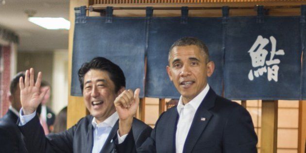 US President Barack Obama (R) and Japanese Prime Minister Shinzo Abe (L) depart after a private dinner at Sukiyabashi Jiro restaurant in Tokyo on April 23, 2014. Obama landed in Tokyo on April 23 to launch an Asian tour dedicated to reinvigorating his policy of 'rebalancing' US foreign policy towards a dynamic Asia. Sukiyabashi Jiro's less-than-plush surroundings notwithstanding, it is the proud possessor of three Michelin stars, and people flock to pay a minimum $300 for 20 pieces of sushi chosen by the 88-year-old patron, Jiro Ono. AFP PHOTO / Jim WATSON (Photo credit should read JIM WATSON/AFP/Getty Images)
