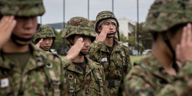 YOKOSUKA, JAPAN - SEPTEMBER 17: Students salute their teacher after finishing rifle training at the Japan Ground Self-Defense Force (JGSDF) High Technical School on September 17, 2014 in Yokosuka, Japan. Each year, approximately 4500 students apply to enter the one and only high school run by JGSDF, and only 300 are accepted. The boys only school was opened in 1955 and caters to students between 15 and 19 years old across three grades. 90% of graduates continue on to careers in the JGSDF. Japan's self-defense stance was changed in July 2014, with the reinterpretation of the country's war-renouncing constitution to allow the Self-Defense Forces (SDF) to exercise the right to collective self-defense, enabling the SDF to engage in military actions for countries who have close relationships with Japan. (Photo by Chris McGrath/Getty Images)