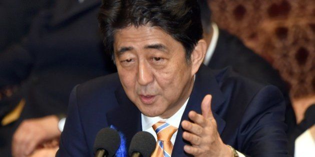 Japan's Prime Minister Shinzo Abe gestures as he answers questions from a parliament member at a committee of the lower house to discuss controversial security bills aimed at beefing up the military in Tokyo on July 10, 2015. Abe, a robust nationalist, has pushed for what he calls a normalisation of Japan's military posture and has sought to loosen restrictions that have bound the so-called Self-Defense Forces to a narrowly defensive role for decades. AFP PHOTO / Toru YAMANAKA (Photo credit should read TORU YAMANAKA/AFP/Getty Images)