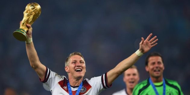 RIO DE JANEIRO, BRAZIL - JULY 13: Bastian Schweinsteiger of Germany kisses the World Cup trophy after defeating Argentina 1-0 in extra time during the 2014 FIFA World Cup Brazil Final match between Germany and Argentina at Maracana on July 13, 2014 in Rio de Janeiro, Brazil. (Photo by Laurence Griffiths/Getty Images)