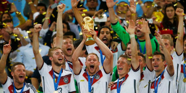 RIO DE JANEIRO, BRAZIL - JULY 13: Benedikt Hoewedes of Germany celebrates with the World Cup trophy after defeating Argentina 1-0 in extra time during the 2014 FIFA World Cup Brazil Final match between Germany and Argentina at Maracana on July 13, 2014 in Rio de Janeiro, Brazil. (Photo by Clive Rose/Getty Images)