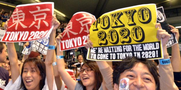 People celebrate as Tokyo wins the host city of the 2020 Olypics at the live-viewing event in Tokyo on September 8, 2013. Tokyo won the right to host the Olympic Games for the second time, overcoming fears about radiation from the stricken Fukushima nuclear plant to land the 2020 edition of the world's biggest sporting event. AFP PHOTO / Yoshikazu TSUNO (Photo credit should read YOSHIKAZU TSUNO/AFP/Getty Images)