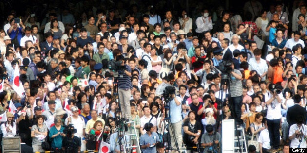 TOKYO, JAPAN - JUNE 22: (CHINA OUT, SOUTH KOREA OUT) Voters listen to the Tokyo Metroolitan Assembly election campaign speech on June 22, 2013 in Tokyo, Japan. (Photo by The Asahi Shimbun/The Asahi Shimbun via Getty Images)