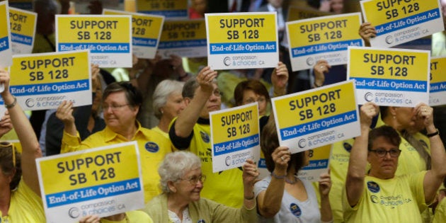 Supporters of proposed legislation allowing doctors to prescribe life ending medication to terminally ill patients, hold up signs of support during a hearing on the bill in the Senate Health Committee at the Capitol in Sacramento, Calif., Wednesday March 25, 2015. Brittany Maynard, a 29-year-old San Francisco Bay Area woman who had terminal cancer, moved to Oregon where she could legally end her life. The bill was approve by the committee by a 5-2 vote.(AP Photo/Rich Pedroncelli)