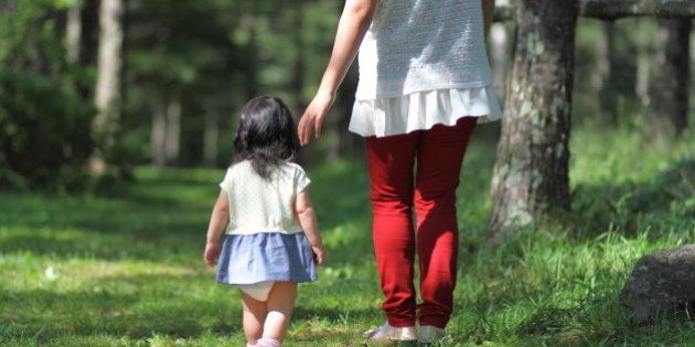 Baby and her mother strolling in the forest.