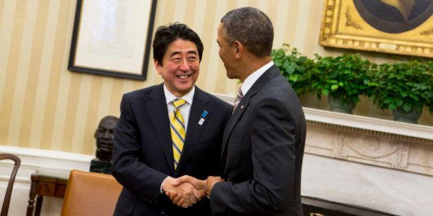 Shinzo Abe, Japan's prime minister, left, shakes hands with U.S. President Barack Obama in the Oval Office of the White House in Washington, D.C., U.S., on Friday, Feb. 22, 2013. Abe is seeking to bolster his country's key alliance as a bulwark against China's territorial claims and North Korea's nuclear ambitions. Photographer: Kristoffer Tripplaar/Pool via Bloomberg