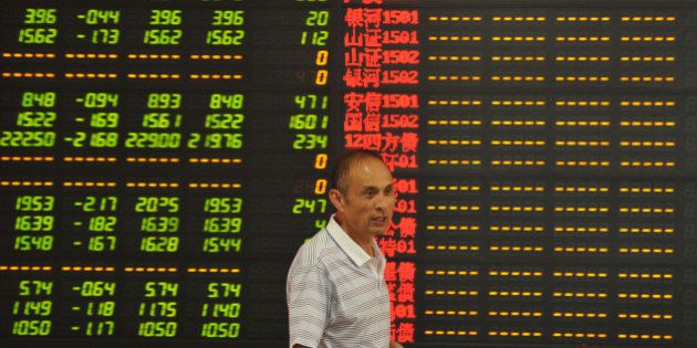 FUYANG, CHINA - JULY 08: (CHINA OUT) An investor observes stock market at a stock exchange hall on July 8, 2015 in Fuyang, Anhui Province of China. Chinese shares dropped sharply on Wednesday with Shanghai Composite Index slipping down to nearly 3,400 points when it opened, the lowest point on that day. It's said that more than 1,700 stocks of Chinese companies in Shanghai Stock Exchange and Shenzhen Stock Exchange reached to decline limit. (Photo by ChinaFotoPress/Getty Images)