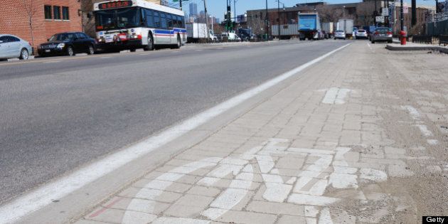 Smog eating paving stones form a bicycle lane on Blue Island Ave, which Chicago city officials havce dubbed the greenest street in America, are seen on April 1, 2013 in Chicago, Illinois. The $14 million project to reshape two miles of Blue Island and Cermak also includes streetlights lights that run on solar and wind power, sidewalks made with recycled concrete, and shrub-filled 'bioswales' to keep storm water out of overtaxed sewers.AFP PHOTO/MIRA OBERMAN (Photo credit should read MIRA OBERMAN/AFP/Getty Images)