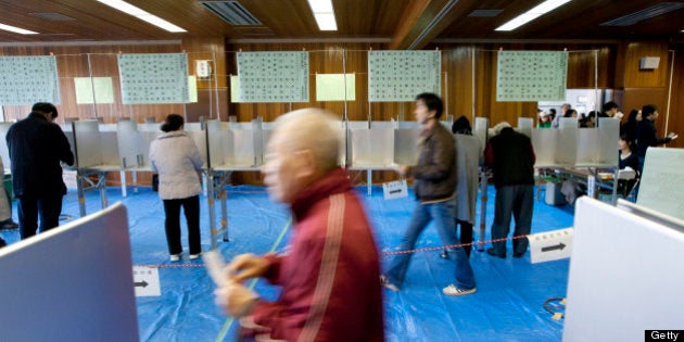 Voters cast their ballots at a polling station in Tokyo, Japan, on Sunday, Dec. 16, 2012. Japanese voters...