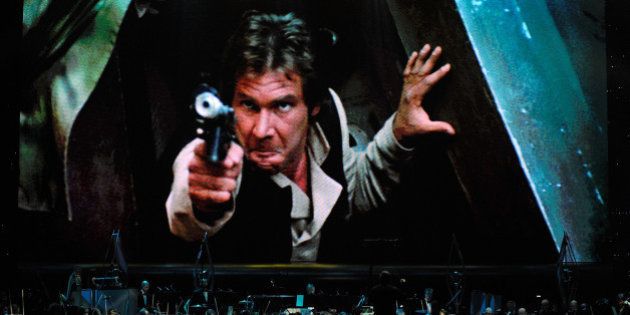 LAS VEGAS - MAY 29: Actor Harrison Ford's Han Solo character from 'Star Wars Episode VI: Return of the Jedi' is shown on screen while musicians perform during 'Star Wars: In Concert' at the Orleans Arena May 29, 2010 in Las Vegas, Nevada. The traveling production features a full symphony orchestra and choir playing music from all six of John Williams' Star Wars scores synchronized with footage from the films displayed on a three-story-tall, HD LED screen. (Photo by Ethan Miller/Getty Images)