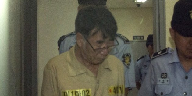 Sewol ferry captain Lee Joon-Seok (C) is escorted upon his arrival at the Gwangju District Court in the southwestern South Korean city of Gwangju on June 24, 2014. Lee Joon-Seok and three crew members are accused of 'homicide through wilful negligence' -- a charge that falls between first-degree murder and manslaughter, but still carries the death penalty. Eleven other members of the crew are being tried on lesser charges of criminal negligence and violations of maritime law. The Sewol was carrying 476 passengers, including 325 students on a school trip, when it sank off the southwest coast on April 16. AFP PHOTO / WONSUK CHOI (Photo credit should read Wonsuk Choi/AFP/Getty Images)