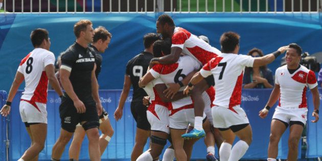 RIO DE JANEIRO, BRAZIL - AUGUST 09: Japan players celebrate victory after the Men's Rugby Sevens Pool C match between New Zealand and Japan on Day 4 of the Rio 2016 Olympic Games at Deodoro Stadium on August 9, 2016 in Rio de Janeiro, Brazil. (Photo by David Rogers/Getty Images)