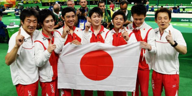 RIO DE JANEIRO, BRAZIL - AUGUST 08: Team Japan poses for photographs after winning the gold medal during the men's team final on Day 3 of the Rio 2016 Olympic Games at the Rio Olympic Arena on August 8, 2016 in Rio de Janeiro, Brazil. (Photo by Matthias Hangst/Getty Images)