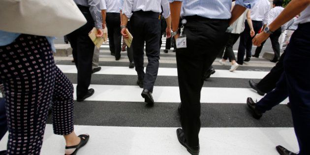 Office workers walk on a pedestrian crossing during a lunch break in Tokyo Monday, June 8, 2015. Japan's economy grew at a faster pace than initially estimated in the January-March quarter on stronger consumer and corporate spending, though economists anticipate slower growth in April-June. The 3.9 percent annualized growth rate announced Monday by the Cabinet Office was sharply higher than the 2.4 percent pace initially reported. (AP Photo/Shizuo Kambayashi)
