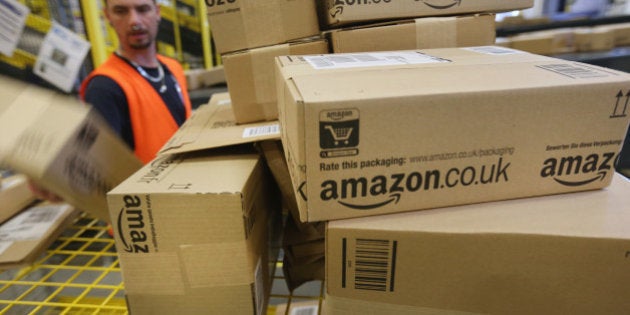 BRIESELANG, GERMANY - SEPTEMBER 04: A worker prepares packages for delivery at an Amazon warehouse on September 4, 2014 in Brieselang, Germany. Germany is online retailer Amazon's second largest market after the USA. Amazon is currently in a standoff with several book publishers over sales conditions and prices for e-books, and hundreds of authors in the US and Europe have written letters in support of the publishers. (Photo by Sean Gallup/Getty Images)