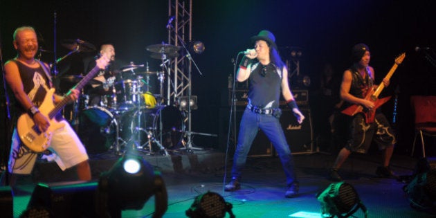 Japanese heavy metal band Loudness (L to R) bassist Masayoshi Yamashita, dummer Masayuki Susuki, singer Minoru Niihara and guitarist Akira Takasaki perform at the band's gig in Hong Kong on August 26, 2012. The band is on tour to promote a new album following their 30th anniversary world tour in 2011. AFP PHOTO / RICHARD A. BROOKS (Photo credit should read RICHARD A. BROOKS/AFP/GettyImages)