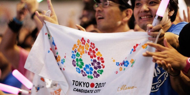 TOKYO, JAPAN - SEPTEMBER 08: Residents of Olympic bid city Tokyo celebrate while holding Tokyo signs...