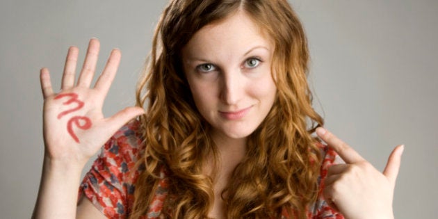 Young woman with word me written on her hand