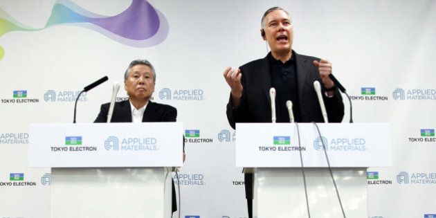 Gary Dickerson, chief executive officer of Applied Materials Inc., right, speaks as Tetsuro 'Terry' Higashi, chairman of Tokyo Electron Ltd., listens during a news conference in Tokyo, Japan, on Tuesday, Sept. 24, 2013. Applied Materials, the largest supplier of chipmaking equipment, agreed to pay $9.39 billion in stock for rival Tokyo Electron and plans to cut costs amid a slump in demand for semiconductors. Photographer: Junko Kimura/Bloomberg via Getty Images