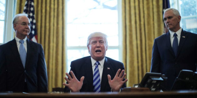 President Trump reacts to the AHCA health care bill being pulled by Congressional Republicans before a vote as he appears with Secretary of Health and Human Services Tom Price (L) and Vice President Mike Pence (R) in the Oval Office of the White House in Washington, U.S., March 24, 2017. REUTERS/Carlos Barria