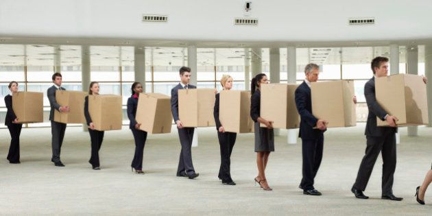 line of business people carrying cardboard boxes