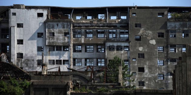 NAGASAKI, JAPAN - SEPTEMBER 23: Hashima Island, as known as 'Battleship island (Gunkan-jima)' is seen on September 23, 2013 in Nagasaki, Japan. The island was a coal mining facility until its closure in 1974, more than 5,000 residents used to live this Japan's first concrete buidling apartments at its peak, there used to be a hospital, schools or even a theatre. (Photo by Masashi Hara/Getty Images)
