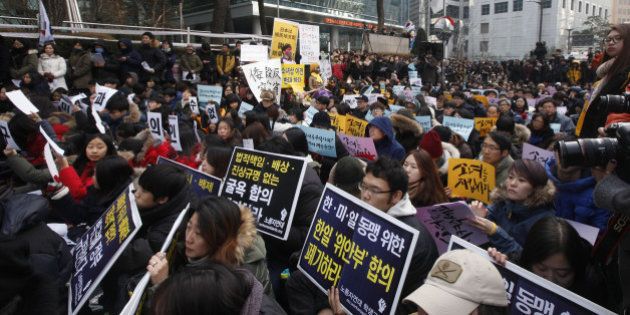 SEOUL, Dec. 30, 2015-- People hold placards during a weekly anti-Japan protest in front of the Japanese embassy in Seoul, South Korea, Dec. 30, 2015. (Xinhua/Yao Qilin via Getty Images)