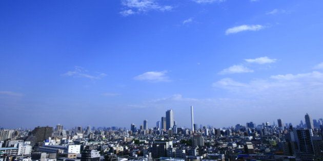 Blue sky with clouds and cityscape