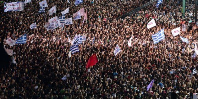 Thousands on 'NO' protesters gather in front of the parliament building in Athens on July 3, 2015. Greek Prime Minister Alexis Tsipras was cheered wildly as he arrived Friday for the rally in Athens' Syntagma Square, two days before a crucial bailout referendum. AFP PHOTO/ Louisa Gouliamaki (Photo credit should read LOUISA GOULIAMAKI/AFP/Getty Images)