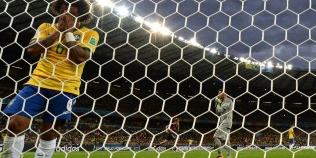 Brazil's defender Marcelo reacts after Germany scored during the semi-final football match between Brazil and Germany at The Mineirao Stadium in Belo Horizonte during the 2014 FIFA World Cup on July 8, 2014. AFP PHOTO / VANDERLEI ALMEIDA (Photo credit should read VANDERLEI ALMEIDA/AFP/Getty Images)