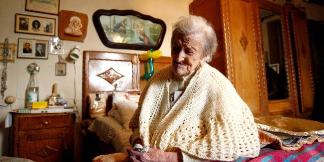 Emma Morano, thought to be the world's oldest person and the last to be born in the 1800s, sits on her bed during her 117th birthday in Verbania, northern Italy November 29, 2016. REUTERS/Alessandro Garofalo