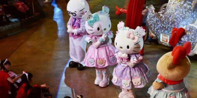 Hello Kitty (2nd R) and her twin sister Mimmy (3rd R) perform with Sanrio characters in the Hello Kitty 40th anniversary parade at Tokyo's Sanrio Puroland on November 1, 2014. Hello Kitty marked her 40th anniversary on November 1, appearing at an upscale Tokyo department store and performing shows at a theme park. AFP PHOTO / KAZUHIRO NOGI (Photo credit should read KAZUHIRO NOGI/AFP/Getty Images)