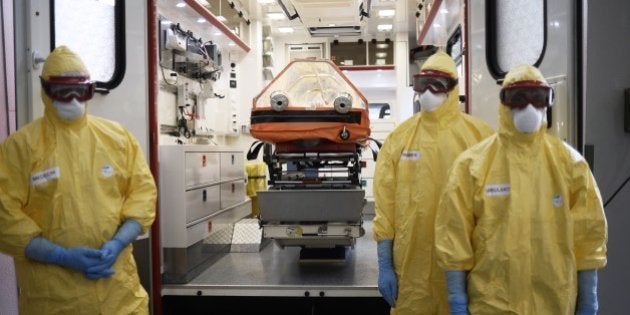 Medical staff wear protective clothes during an exercise to prepare the service in case of an Ebola virus outbreak on October 24, 2014 at the SAMU headquarters in Paris. European Union leaders agreed to boost aid to combat the deadly Ebola virus in west Africa to one billion euros ($1.26 billion), EU president Herman Van Rompuy said. So far, there have been some 10,000 cases but experts have warned that infections could soar to 10,000 per week by early December -- a terrifying prospect for a disease with a death rate running at 70 percent. AFP PHOTO / STEPHANE DE SAKUTIN (Photo credit should read STEPHANE DE SAKUTIN/AFP/Getty Images)