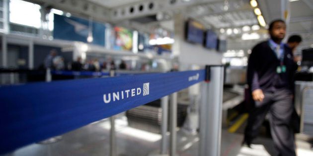 An airport worker walks through the United Airlines terminal at O'Hare International Airport on April 12, 2017 in Chicago, Illinois. United Airlines has been criticized in recent days after airport police officers physically removed passenger Dr. David Dao from his seat and dragged him off the airplane, after he was requested to give up his seat for United Airline crew members on a flight from Chicago to Louisville, Kentucky Sunday night. / AFP PHOTO / Joshua LOTT (Photo credit should read JOSHUA LOTT/AFP/Getty Images)