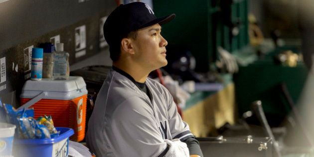 CLEVELAND, OH - JULY 8: Starting pitcher Masahiro Tanaka #19 of the New York Yankees sits in the dugout...